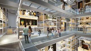 An architect's mock up of how Storehouse will look. Cut out figures are standing in front of racking with storage crates. some are opened at one end to reveal vases. The figures are standing on a raised metal walkway, there are two other floors visible through an open central area.